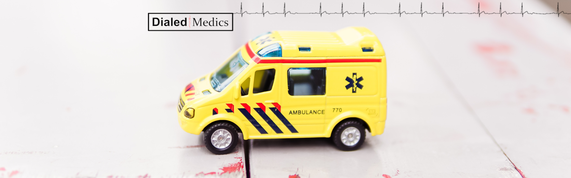Yellow ambulance with Dialed Medics logo.